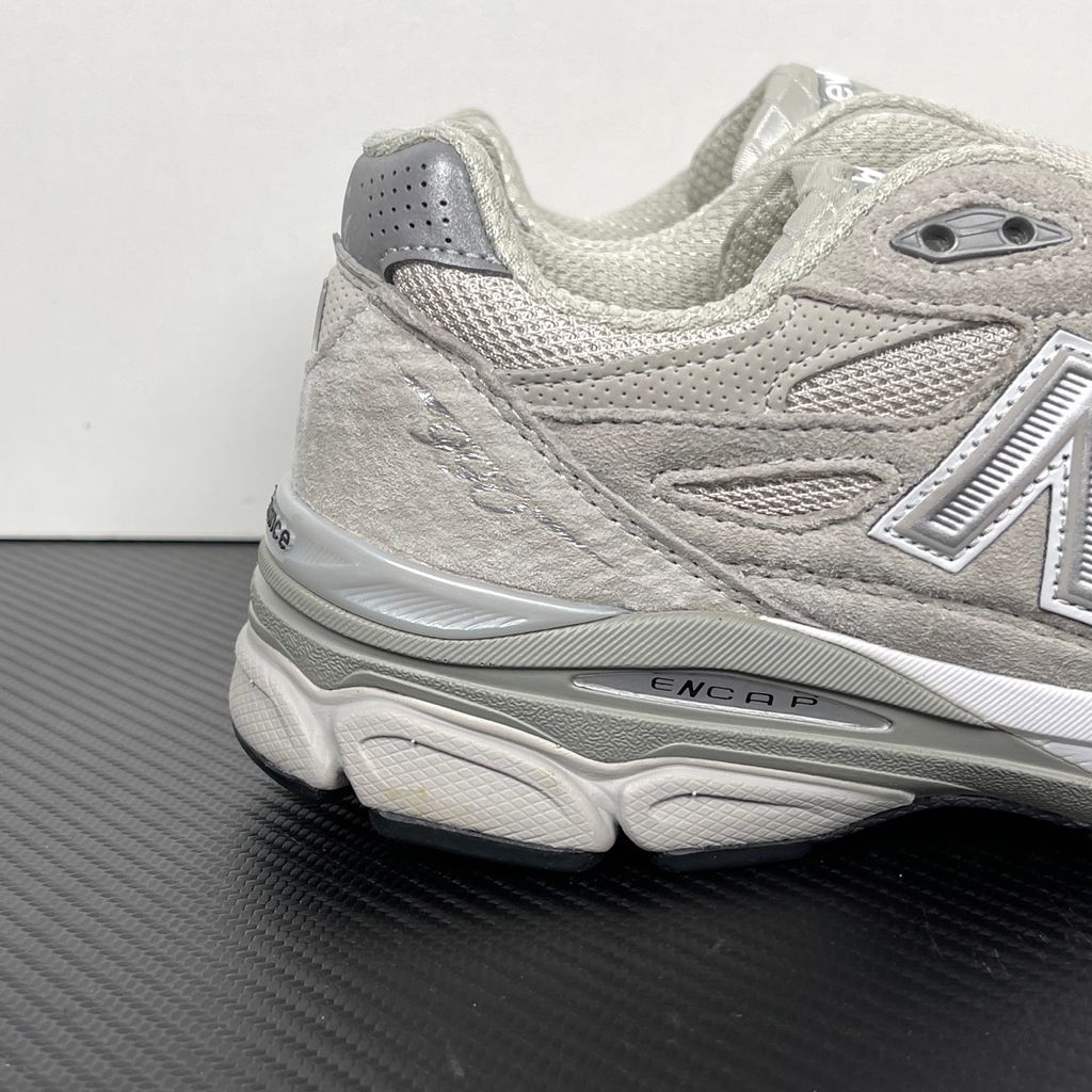 Side profile of the collaborative New Balance 990v3 MiUSA sneaker in the exclusive Kith Hallow colorway, featuring a premium tonal pigskin suede and mesh upper, a silver reflective 'N' logo, and a split ENCAP midsole.