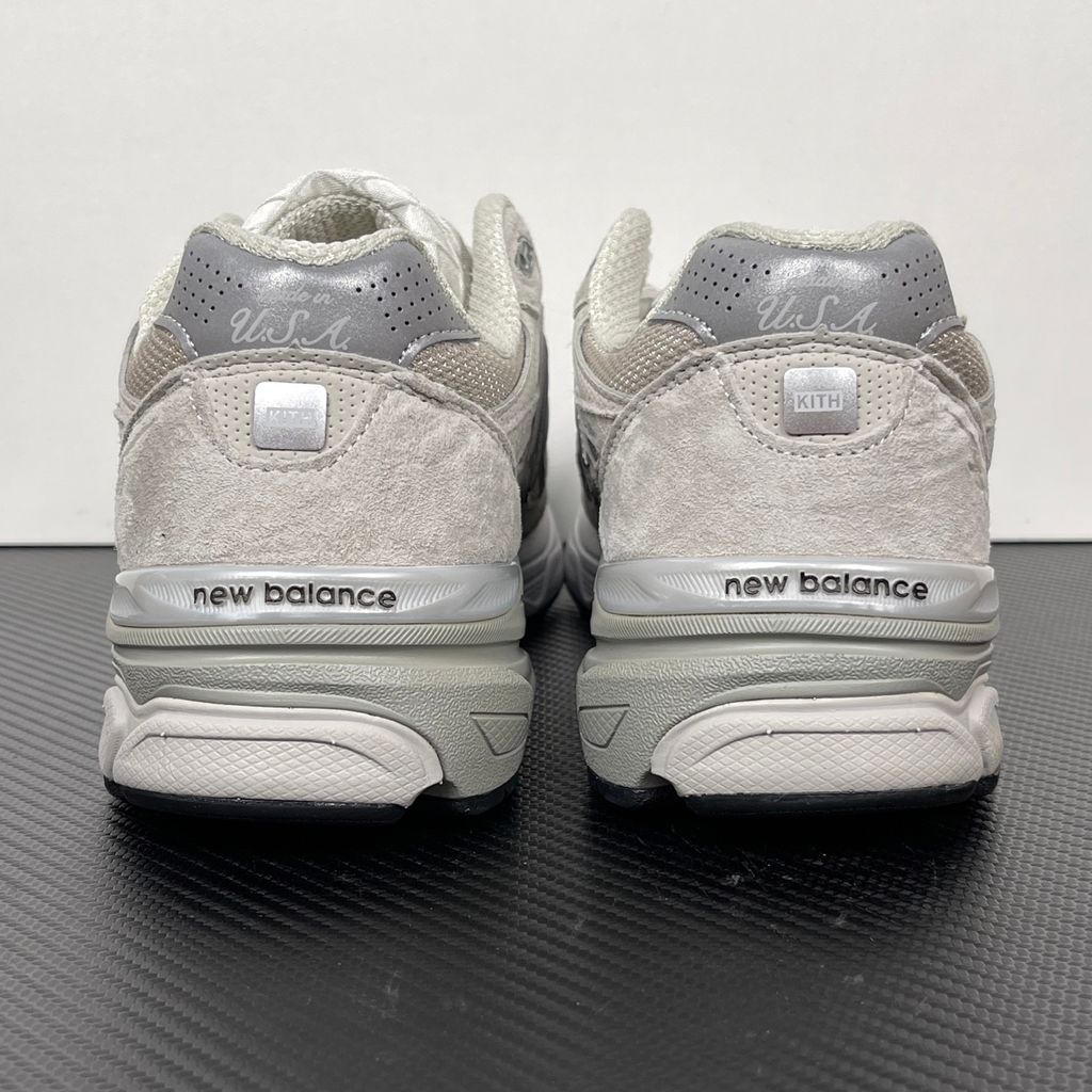 Side profile of the collaborative New Balance 990v3 MiUSA sneaker in the exclusive Kith Hallow colorway, featuring a premium tonal pigskin suede and mesh upper, a silver reflective 'N' logo, and a split ENCAP midsole.
