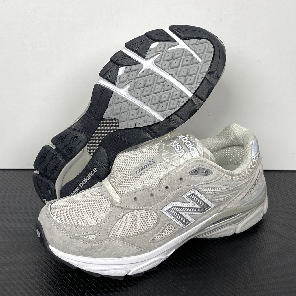 Side profile of the collaborative New Balance 990v3 MiUSA sneaker in the exclusive Kith Hallow colorway, featuring a premium tonal pigskin suede and mesh upper, a silver reflective 'N' logo, and a split ENCAP midsole.