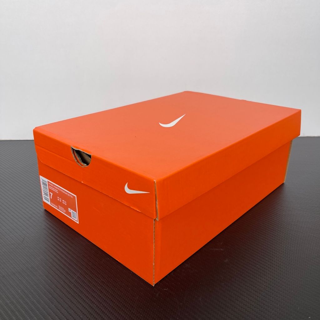 Side profile of the Nike Vomero Premium QS sneaker in a refined Fleur De-Lis and Geyser Grey colorway, featuring a layered mesh and premium synthetic upper, signature plastic side cage, and a responsive Zoom Air midsole.
