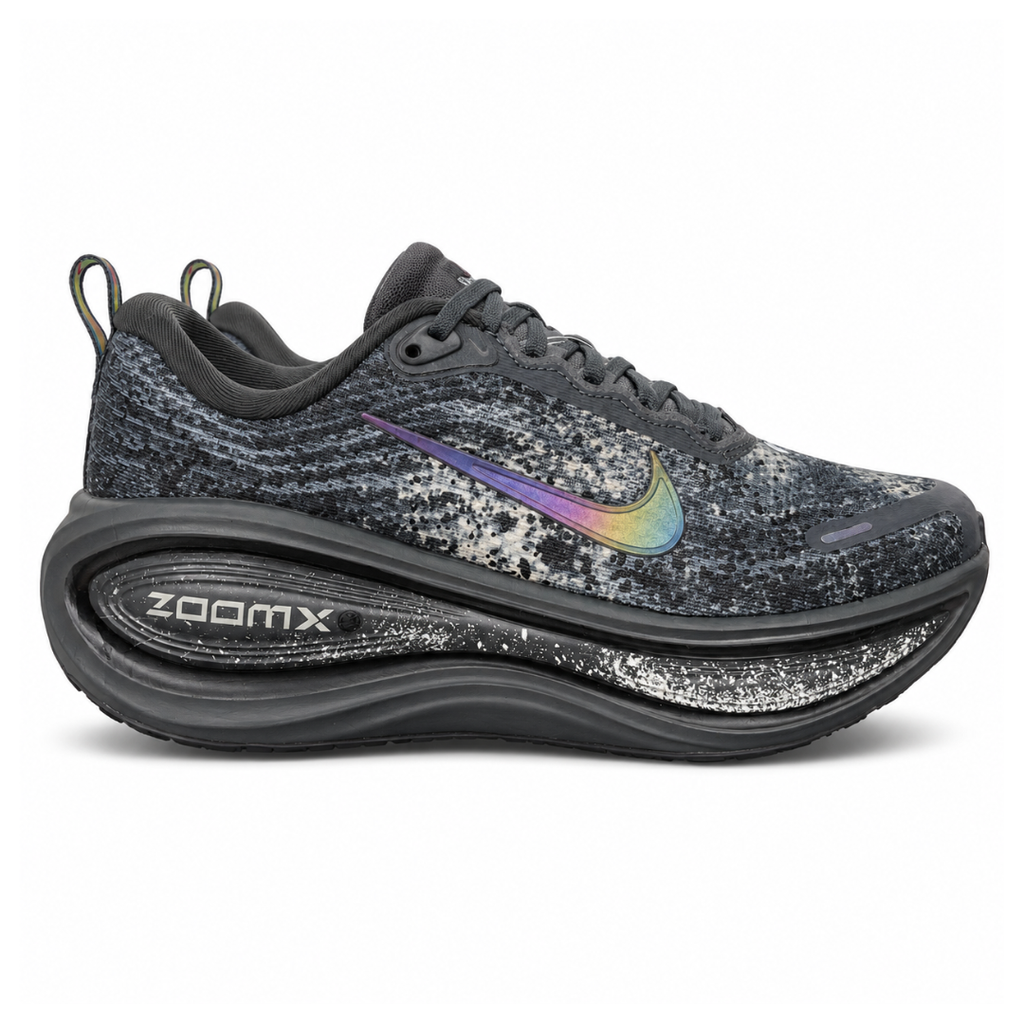 Side profile of the Nike Vomero Plus sneaker in a dark Anthracite and Black colorway with subtle Oatmeal accents, featuring a layered mesh and synthetic upper, a structured midfoot cage, and a responsive Zoom Air midsole.