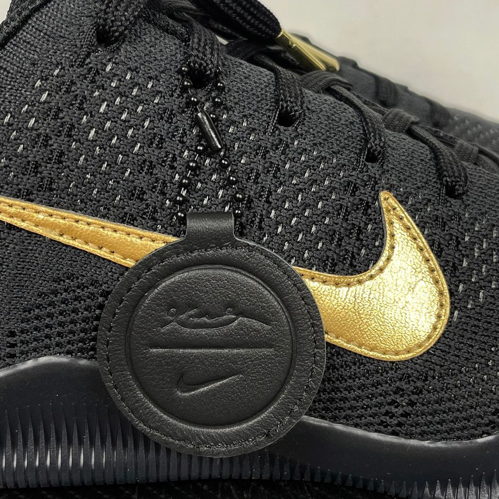 Side profile of the Nike Kobe 11 Elite Low Protro basketball shoe in the Fade to Black colorway, featuring a sleek dark grey-to-black gradient Flyknit upper, a tonal metallic Swoosh, and a solid black rubber outsole.