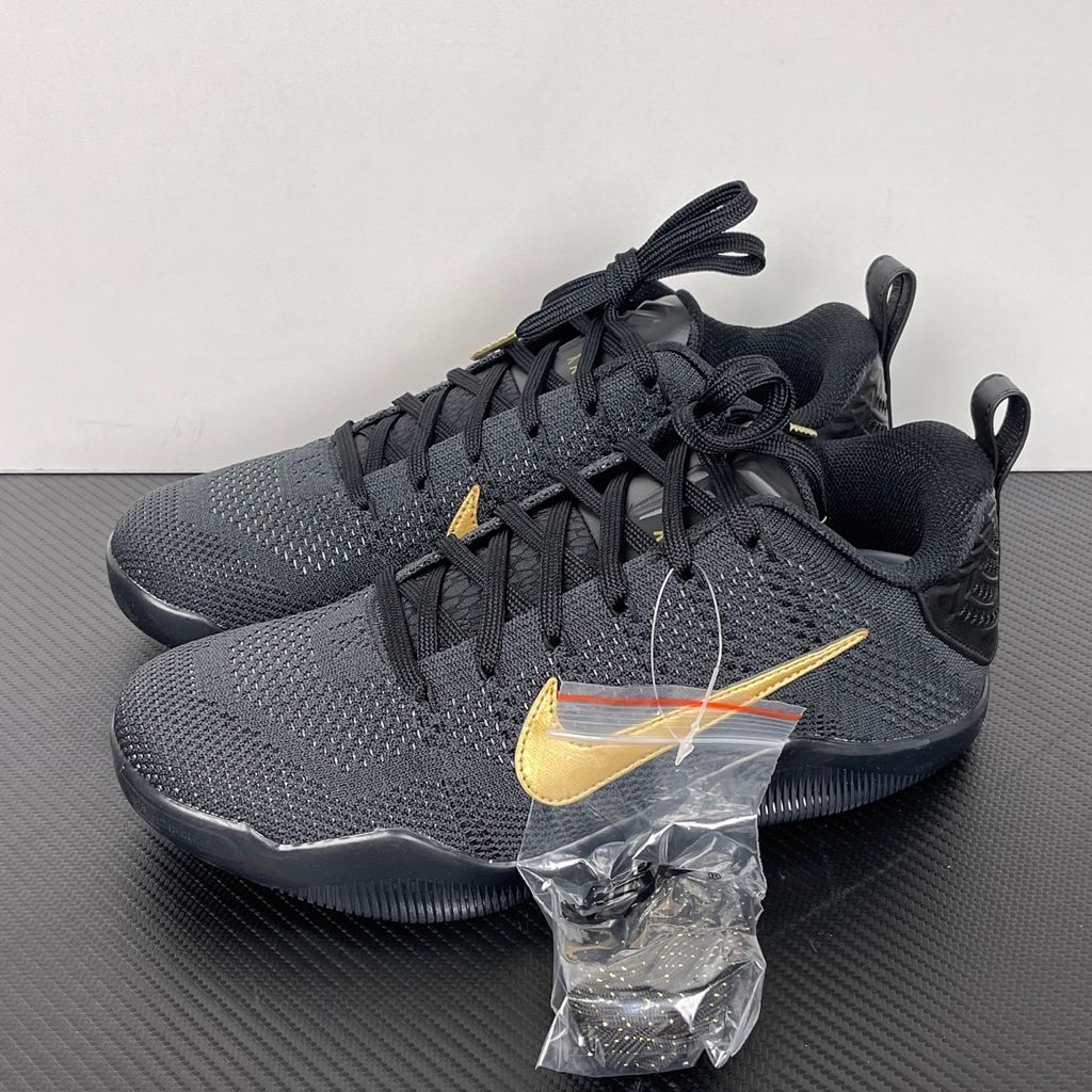 Side profile of the Nike Kobe 11 Elite Low Protro basketball shoe in the Fade to Black colorway, featuring a sleek dark grey-to-black gradient Flyknit upper, a tonal metallic Swoosh, and a solid black rubber outsole.
