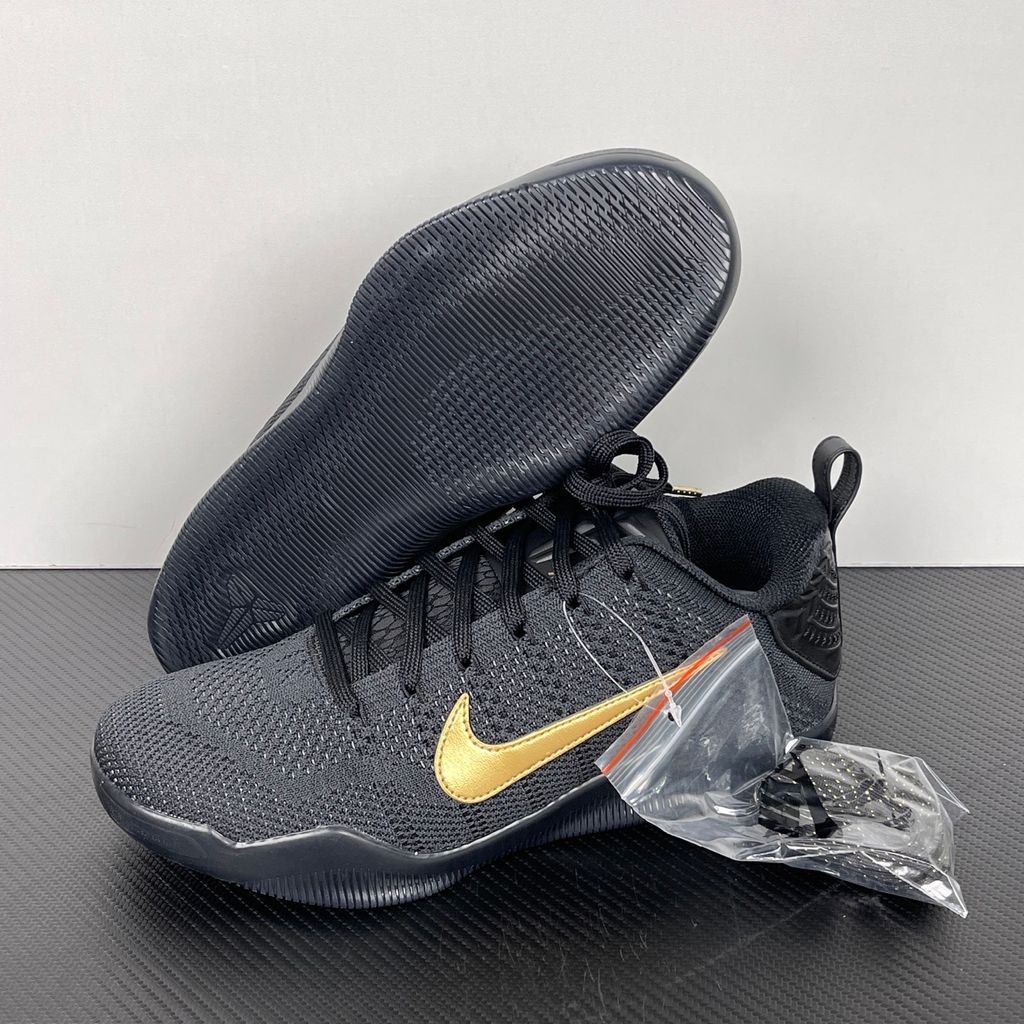 Side profile of the Nike Kobe 11 Elite Low Protro basketball shoe in the Fade to Black colorway, featuring a sleek dark grey-to-black gradient Flyknit upper, a tonal metallic Swoosh, and a solid black rubber outsole.