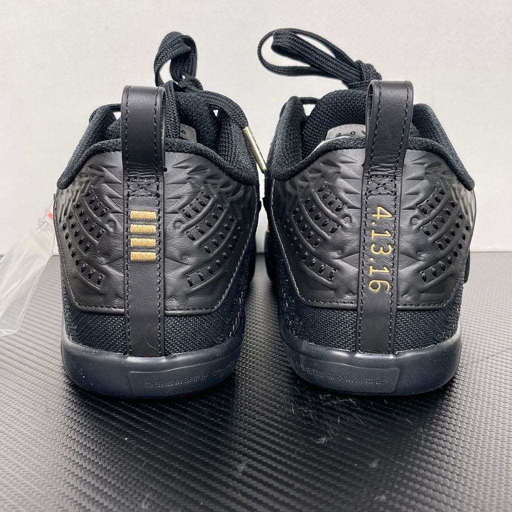Side profile of the Nike Kobe 11 Elite Low Protro basketball shoe in the Fade to Black colorway, featuring a sleek dark grey-to-black gradient Flyknit upper, a tonal metallic Swoosh, and a solid black rubber outsole.