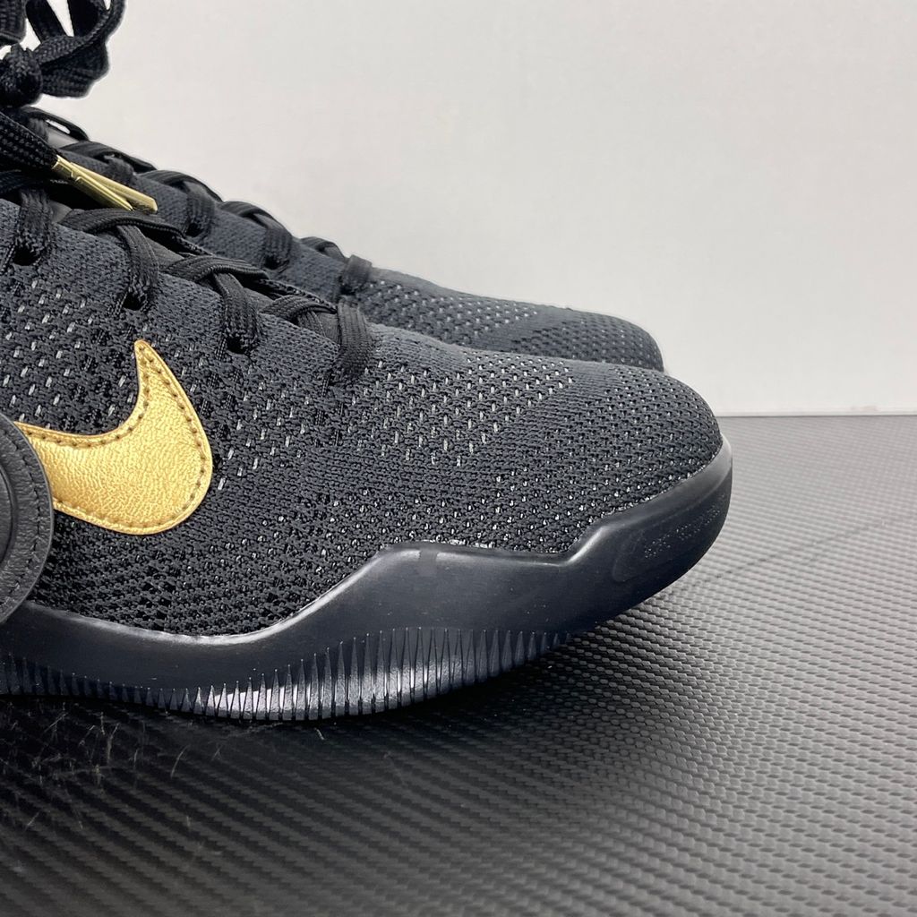 Side profile of the Nike Kobe 11 Elite Low Protro basketball shoe in the Fade to Black colorway, featuring a sleek dark grey-to-black gradient Flyknit upper, a tonal metallic Swoosh, and a solid black rubber outsole.