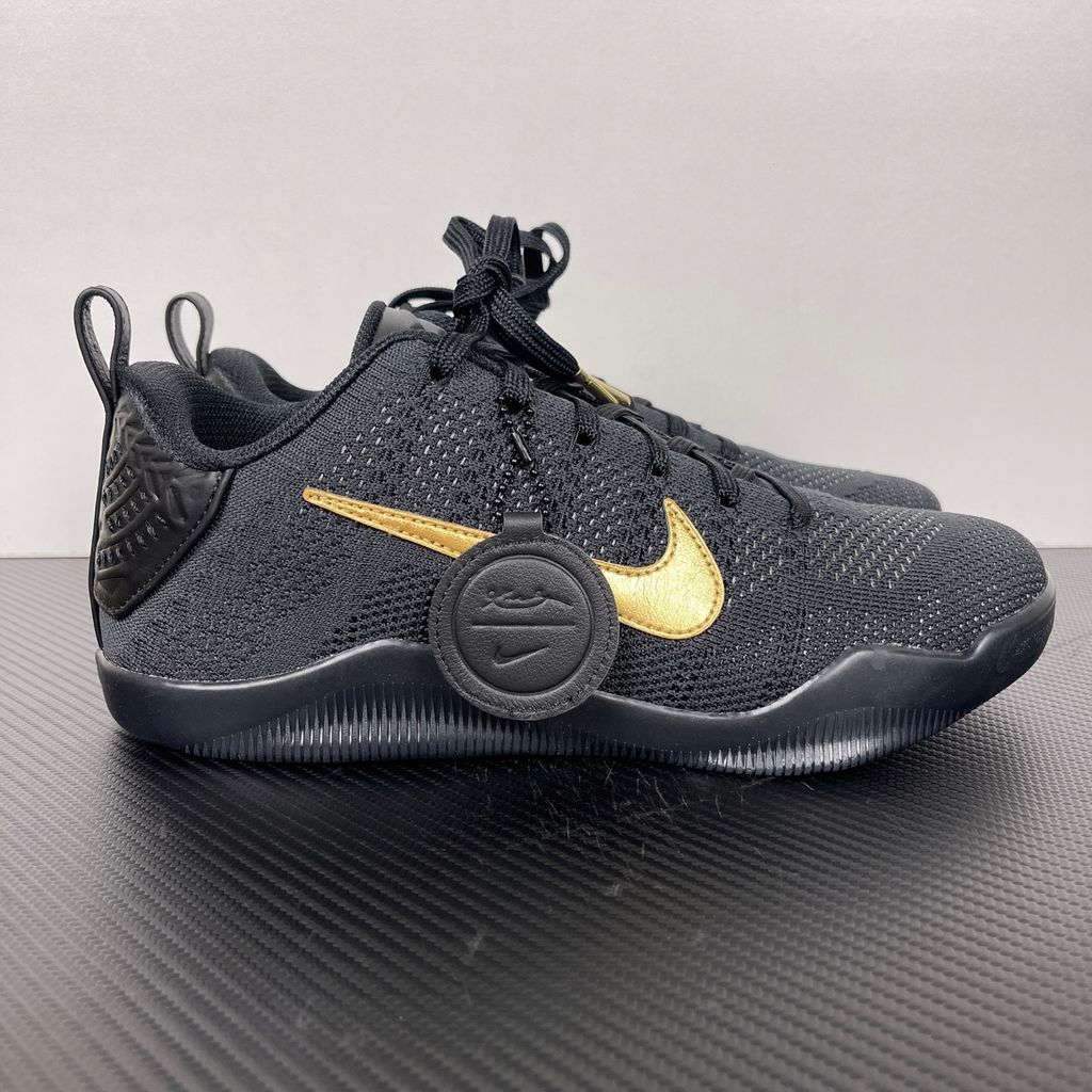 Side profile of the Nike Kobe 11 Elite Low Protro basketball shoe in the Fade to Black colorway, featuring a sleek dark grey-to-black gradient Flyknit upper, a tonal metallic Swoosh, and a solid black rubber outsole.