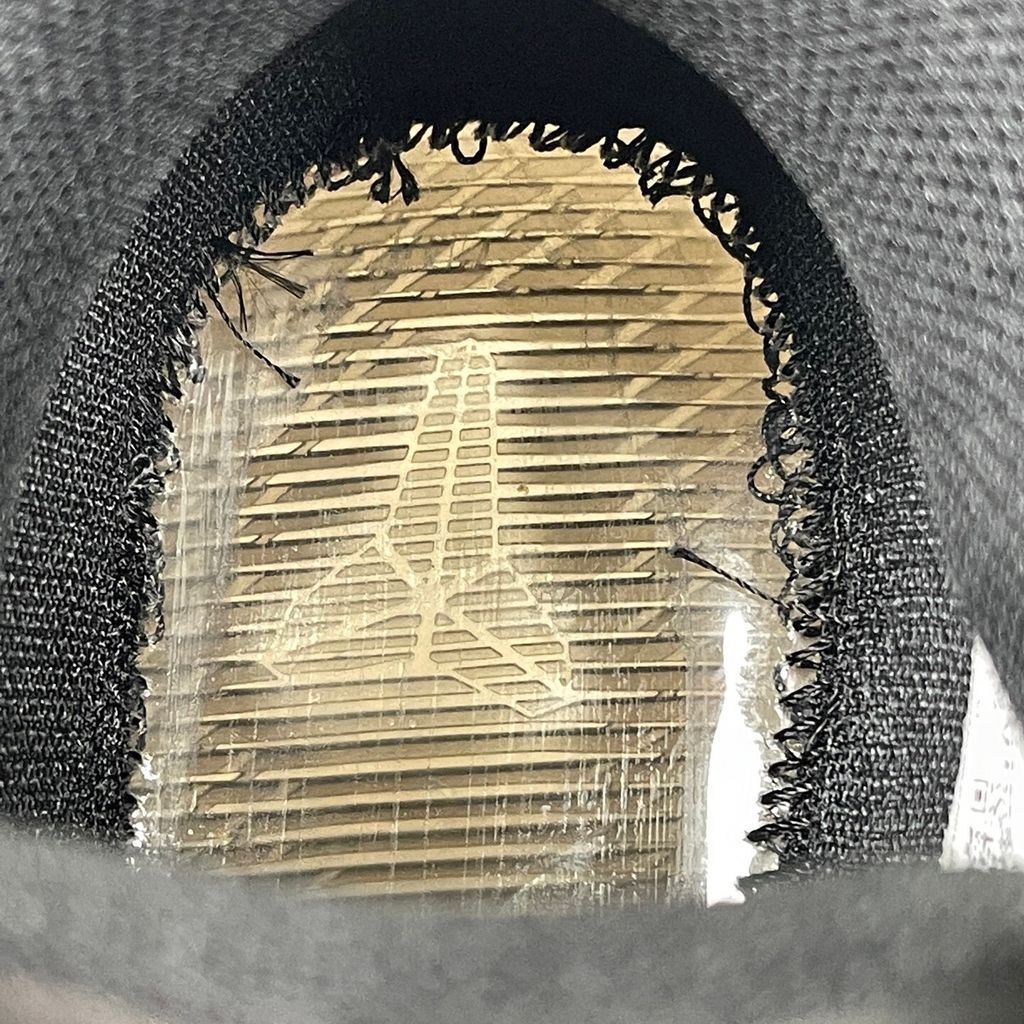 Side profile of the Nike Kobe 11 Elite Low Protro basketball shoe in the Fade to Black colorway, featuring a sleek dark grey-to-black gradient Flyknit upper, a tonal metallic Swoosh, and a solid black rubber outsole.