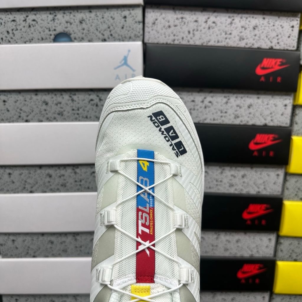Side profile of the Salomon XT-4 OG trail running sneaker in a clean White and Lunar Rock colorway, featuring a durable TPU film mesh upper, a Quicklace system, and an aggressive Contagrip rubber outsole.