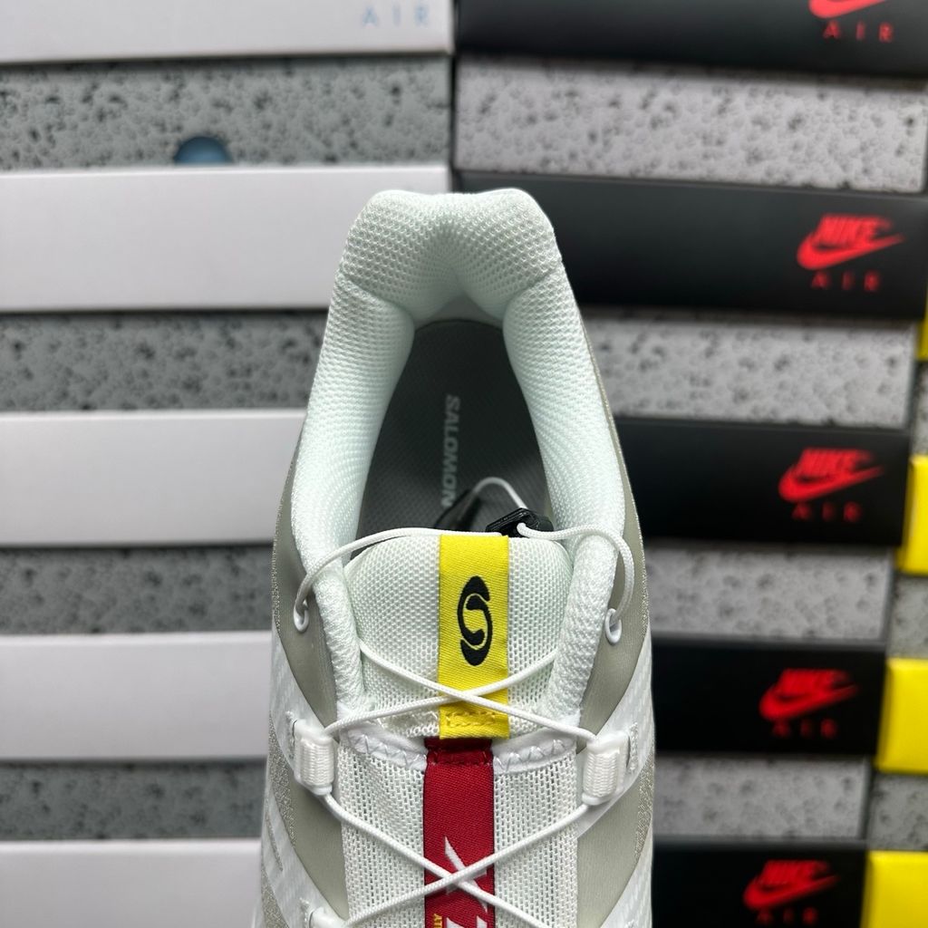 Side profile of the Salomon XT-4 OG trail running sneaker in a clean White and Lunar Rock colorway, featuring a durable TPU film mesh upper, a Quicklace system, and an aggressive Contagrip rubber outsole.