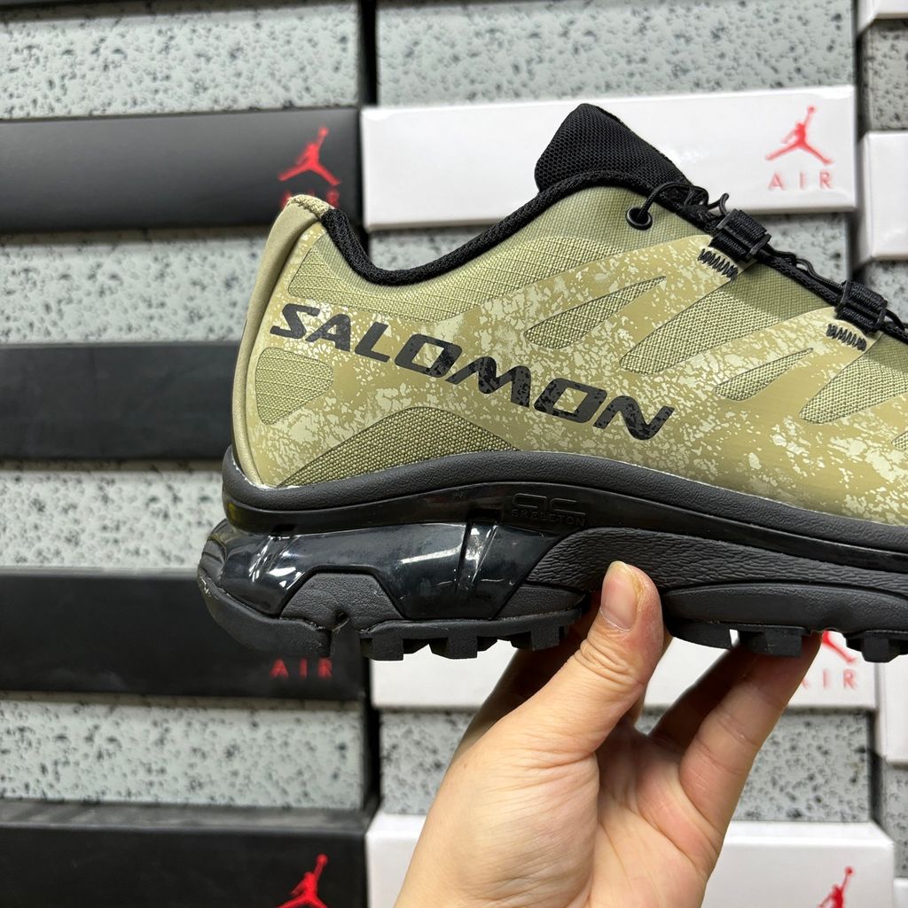 Side profile of the Salomon XT-4 OG trail running sneaker in an earthy Protective Aloe green and Black colorway, featuring a durable TPU film mesh upper, a Quicklace system, and an aggressive Contagrip rubber outsole.