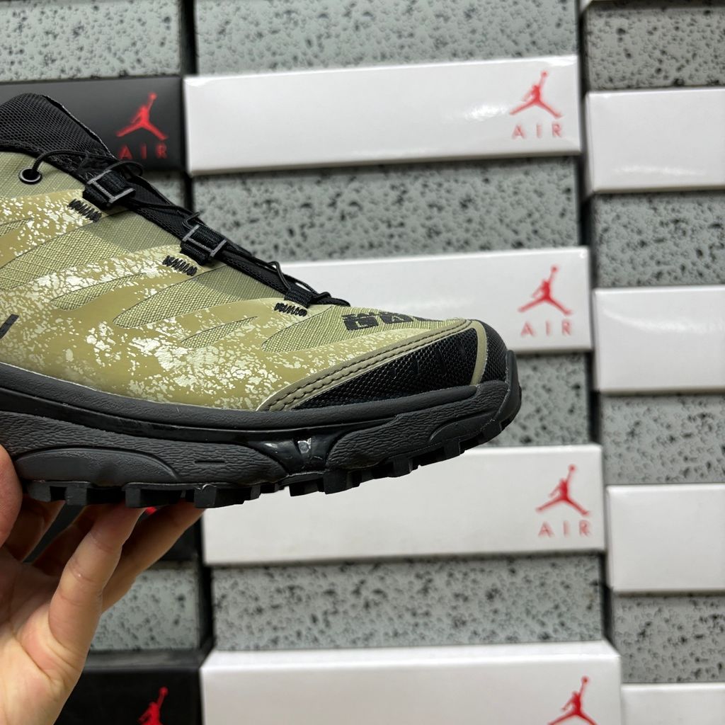 Side profile of the Salomon XT-4 OG trail running sneaker in an earthy Protective Aloe green and Black colorway, featuring a durable TPU film mesh upper, a Quicklace system, and an aggressive Contagrip rubber outsole.