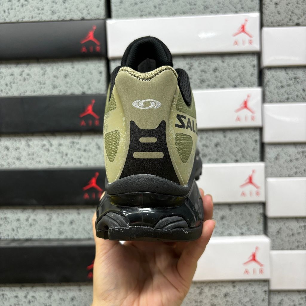 Side profile of the Salomon XT-4 OG trail running sneaker in an earthy Protective Aloe green and Black colorway, featuring a durable TPU film mesh upper, a Quicklace system, and an aggressive Contagrip rubber outsole.