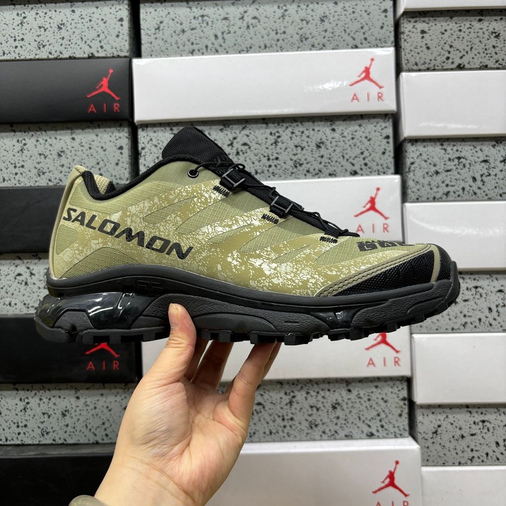 Side profile of the Salomon XT-4 OG trail running sneaker in an earthy Protective Aloe green and Black colorway, featuring a durable TPU film mesh upper, a Quicklace system, and an aggressive Contagrip rubber outsole.