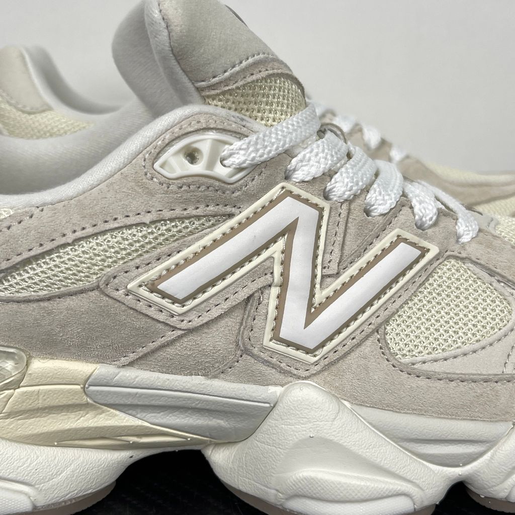 Side profile of the New Balance 9060 sneaker featuring a breathable Sea Salt mesh upper, premium Timberwolf suede overlays, a classic 'N' logo, and a dramatic, chunky wavy midsole with ABZORB cushioning.