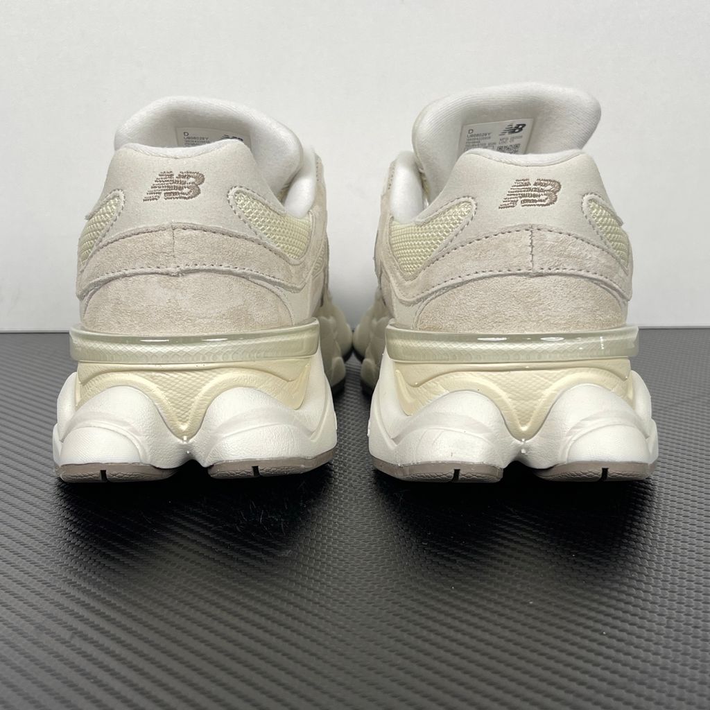 Side profile of the New Balance 9060 sneaker featuring a breathable Sea Salt mesh upper, premium Timberwolf suede overlays, a classic 'N' logo, and a dramatic, chunky wavy midsole with ABZORB cushioning.