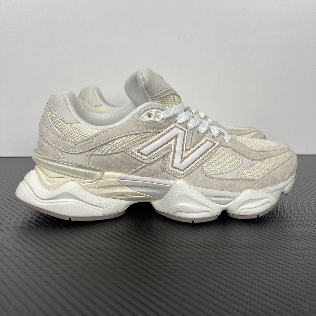 Side profile of the New Balance 9060 sneaker featuring a breathable Sea Salt mesh upper, premium Timberwolf suede overlays, a classic 'N' logo, and a dramatic, chunky wavy midsole with ABZORB cushioning.