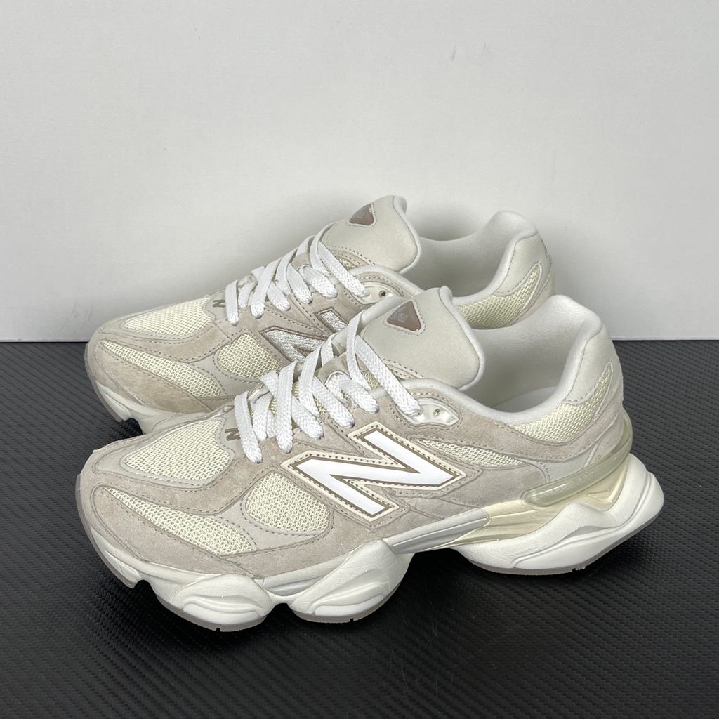 Side profile of the New Balance 9060 sneaker featuring a breathable Sea Salt mesh upper, premium Timberwolf suede overlays, a classic 'N' logo, and a dramatic, chunky wavy midsole with ABZORB cushioning.