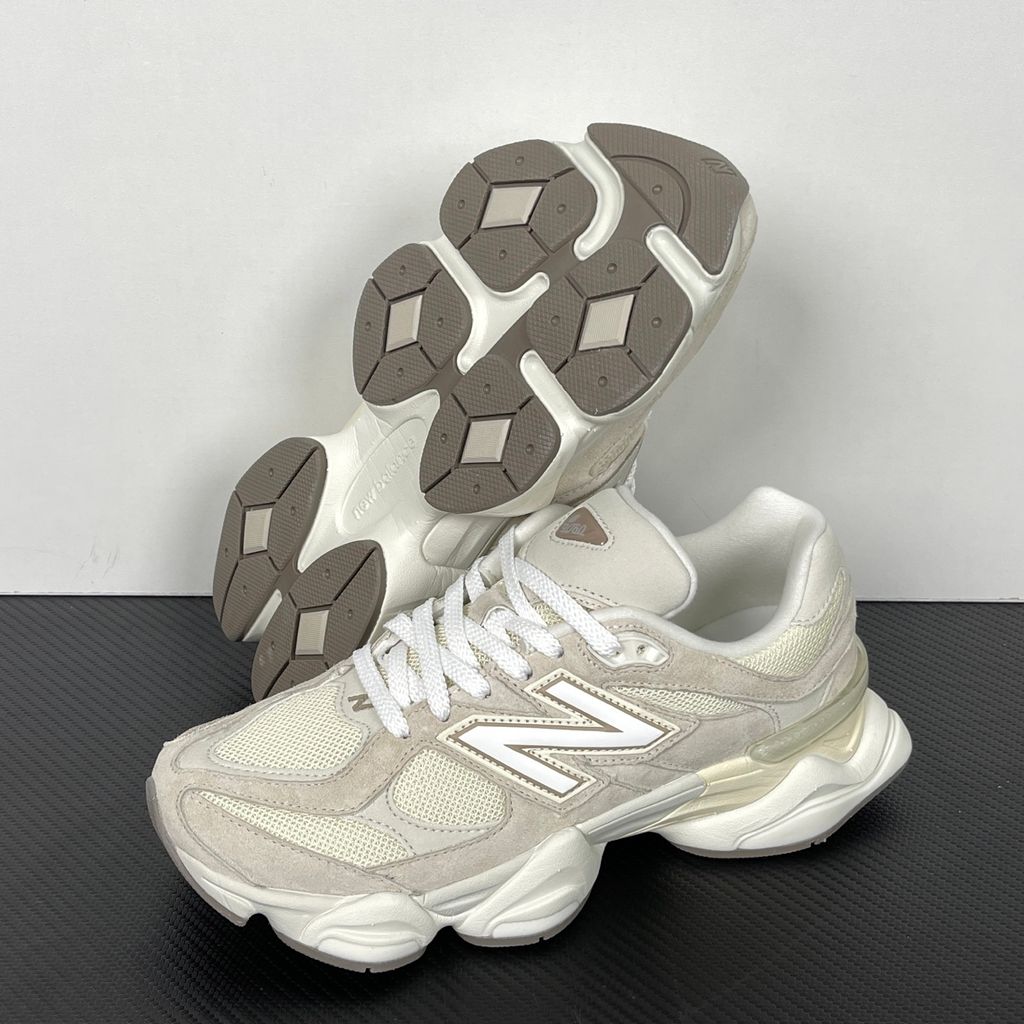 Side profile of the New Balance 9060 sneaker featuring a breathable Sea Salt mesh upper, premium Timberwolf suede overlays, a classic 'N' logo, and a dramatic, chunky wavy midsole with ABZORB cushioning.