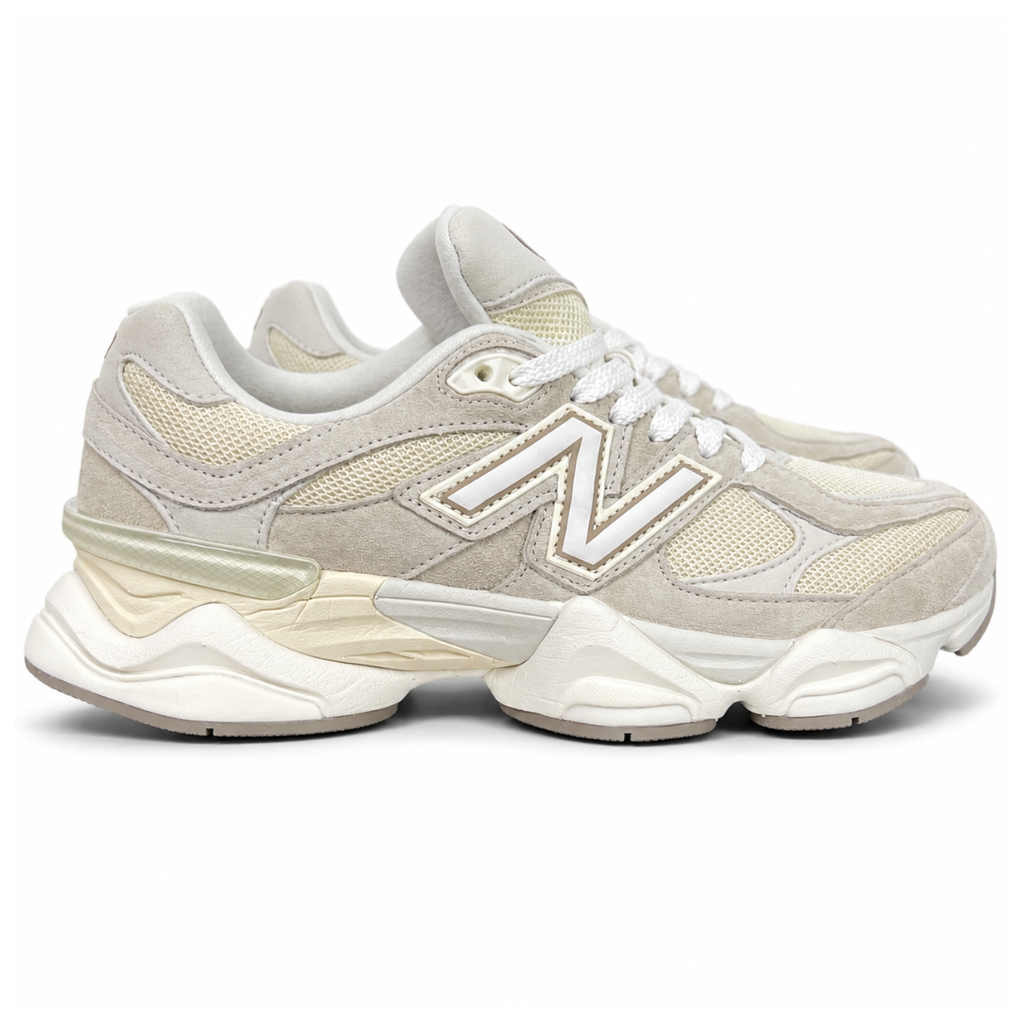 Side profile of the New Balance 9060 sneaker featuring a breathable Sea Salt mesh upper, premium Timberwolf suede overlays, a classic 'N' logo, and a dramatic, chunky wavy midsole with ABZORB cushioning.
