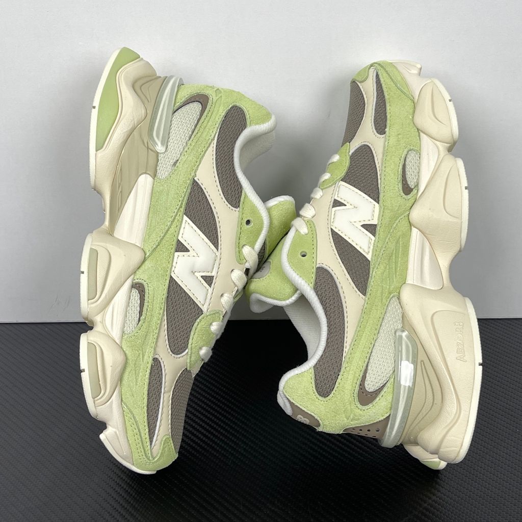 Side profile of the Women's New Balance 9060 sneaker featuring a breathable Dry Lime mesh upper, premium Thunder Brown suede overlays, a classic 'N' logo, and a dramatic, chunky wavy midsole with ABZORB cushioning.