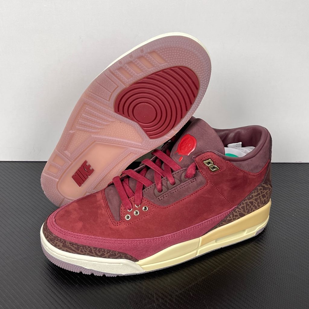 Side profile of the Air Jordan 3 Retro PRM 'Bin 23' sneaker featuring rich, premium tumbled leather, classic elephant print overlays on the toe and heel, the exclusive red Bin 23 wax seal stamp, and a classic midsole with a visible Air unit.