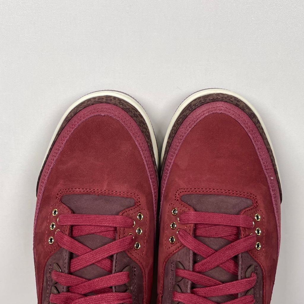Side profile of the Air Jordan 3 Retro PRM 'Bin 23' sneaker featuring rich, premium tumbled leather, classic elephant print overlays on the toe and heel, the exclusive red Bin 23 wax seal stamp, and a classic midsole with a visible Air unit.