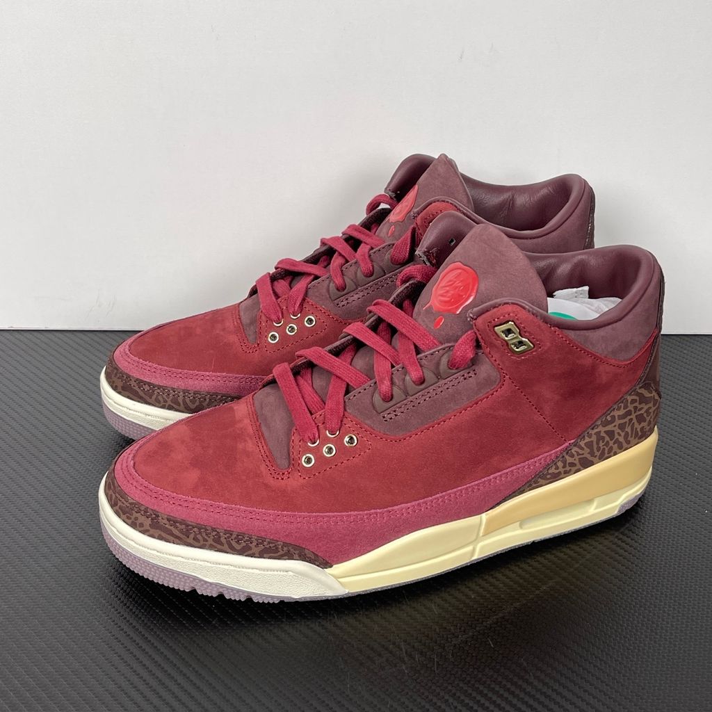 Side profile of the Air Jordan 3 Retro PRM 'Bin 23' sneaker featuring rich, premium tumbled leather, classic elephant print overlays on the toe and heel, the exclusive red Bin 23 wax seal stamp, and a classic midsole with a visible Air unit.