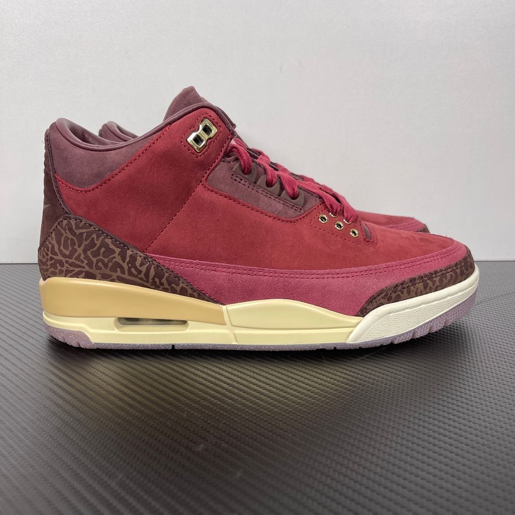 Side profile of the Air Jordan 3 Retro PRM 'Bin 23' sneaker featuring rich, premium tumbled leather, classic elephant print overlays on the toe and heel, the exclusive red Bin 23 wax seal stamp, and a classic midsole with a visible Air unit.