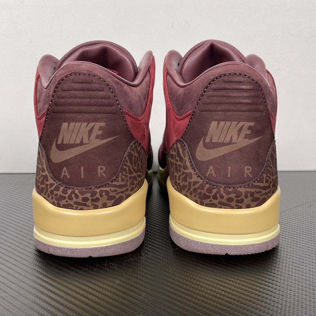 Side profile of the Air Jordan 3 Retro PRM 'Bin 23' sneaker featuring rich, premium tumbled leather, classic elephant print overlays on the toe and heel, the exclusive red Bin 23 wax seal stamp, and a classic midsole with a visible Air unit.