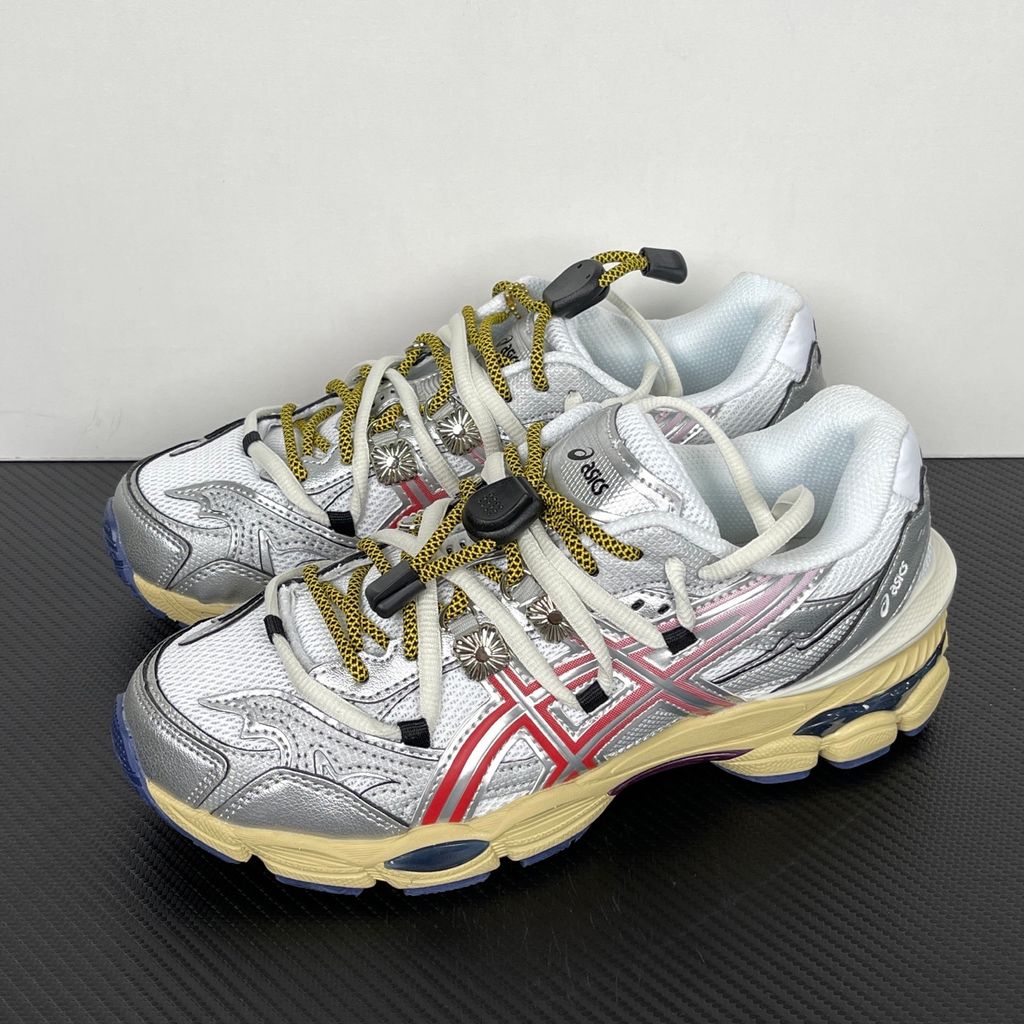 Side profile of the collaborative ASICS x TOGA Gel-Cumulus 16 sneaker in a White, Red, and Pure Silver colorway, featuring a breathable mesh upper, striking metallic silver overlays, bold red accents, and a sculpted GEL-cushioned midsole.