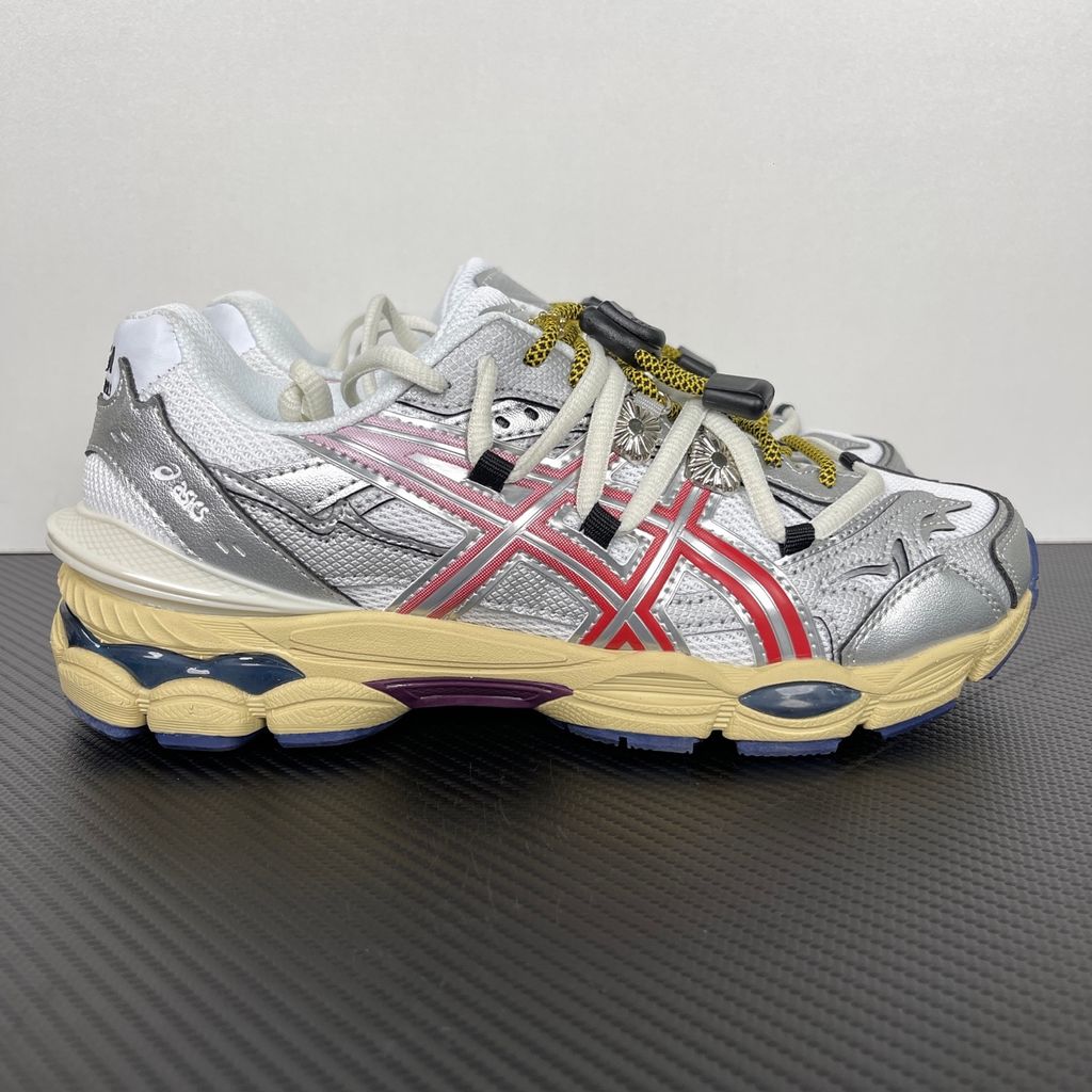 Side profile of the collaborative ASICS x TOGA Gel-Cumulus 16 sneaker in a White, Red, and Pure Silver colorway, featuring a breathable mesh upper, striking metallic silver overlays, bold red accents, and a sculpted GEL-cushioned midsole.