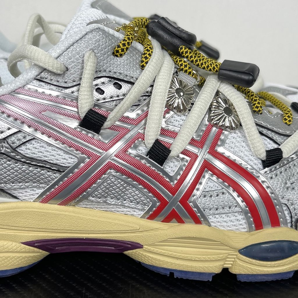 Side profile of the collaborative ASICS x TOGA Gel-Cumulus 16 sneaker in a White, Red, and Pure Silver colorway, featuring a breathable mesh upper, striking metallic silver overlays, bold red accents, and a sculpted GEL-cushioned midsole.