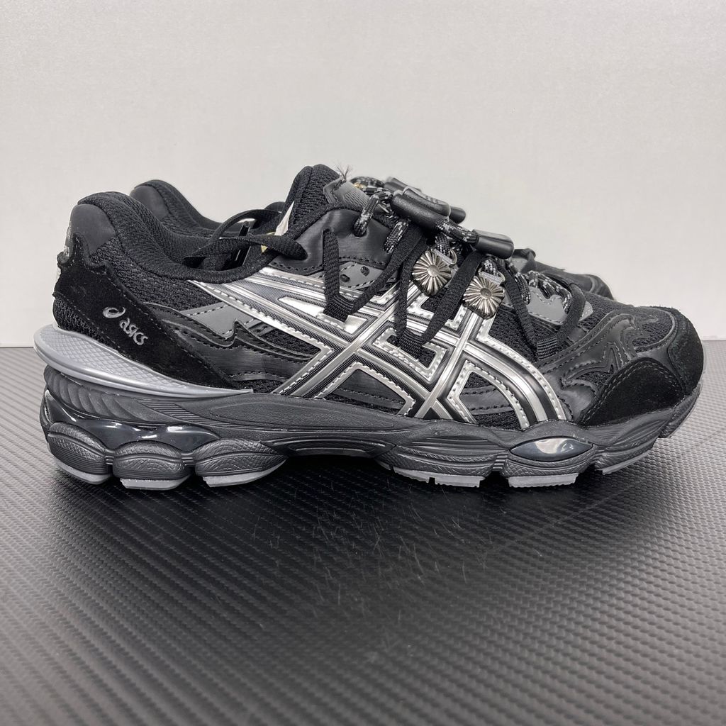 Side profile of the collaborative ASICS x TOGA Gel-Cumulus 16 sneaker in a Grey, Black, and Pure Silver colorway, featuring a breathable mesh upper, striking metallic silver overlays, sleek black accents, and a sculpted GEL-cushioned midsole.