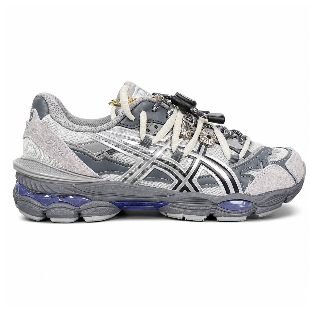 side profile of the collaborative ASICS x TOGA Gel-Cumulus 16 sneaker in a Grey, Black, and Pure Silver colorway, featuring a breathable mesh upper, striking metallic silver overlays, sleek black accents, and a sculpted GEL-cushioned midsole.