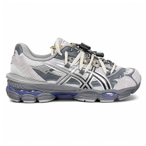 side profile of the collaborative ASICS x TOGA Gel-Cumulus 16 sneaker in a Grey, Black, and Pure Silver colorway, featuring a breathable mesh upper, striking metallic silver overlays, sleek black accents, and a sculpted GEL-cushioned midsole.