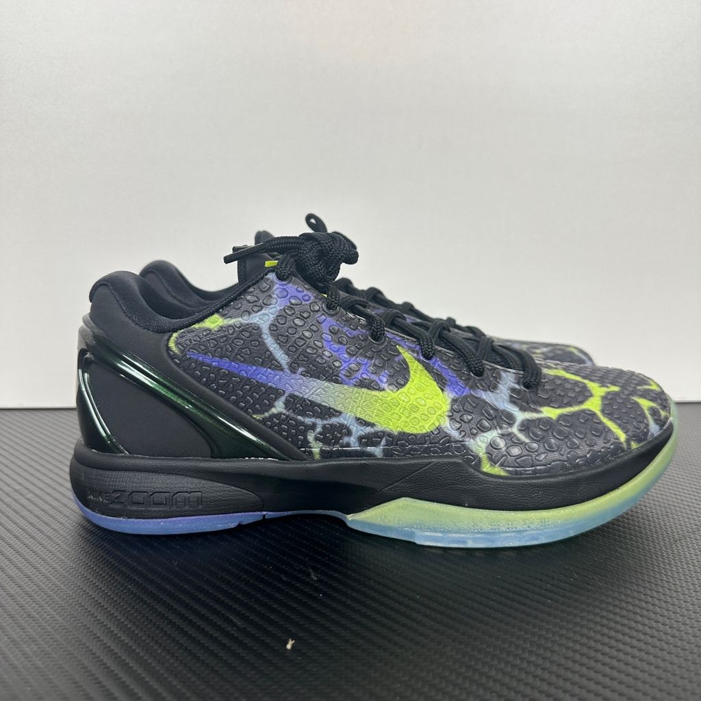 Side profile of the Nike Kobe 6 Protro "Coals" basketball shoe, featuring a stealthy black textured reptilian scale upper, vibrant Venom Green Swoosh and laces, contrasting Purple Venom accents, and a responsive Zoom Air midsole.