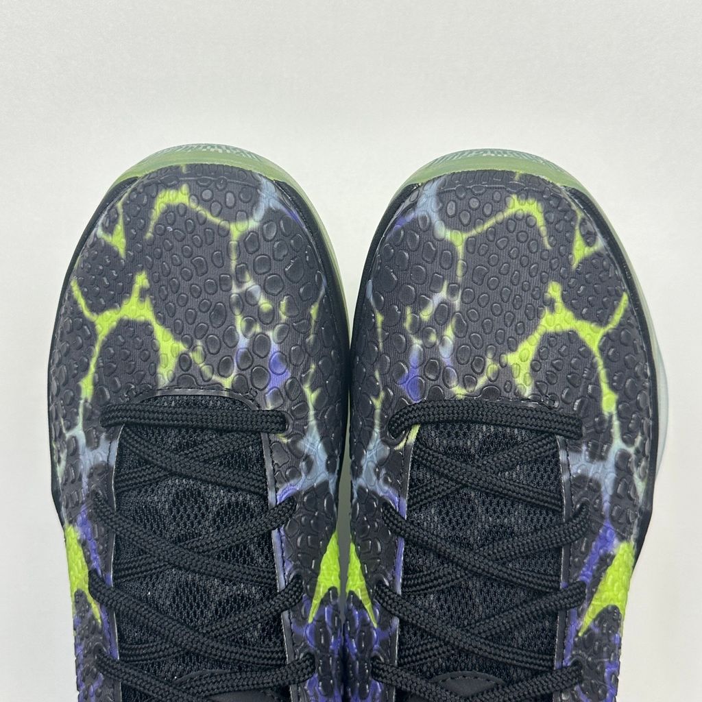 Side profile of the Nike Kobe 6 Protro "Coals" basketball shoe, featuring a stealthy black textured reptilian scale upper, vibrant Venom Green Swoosh and laces, contrasting Purple Venom accents, and a responsive Zoom Air midsole.