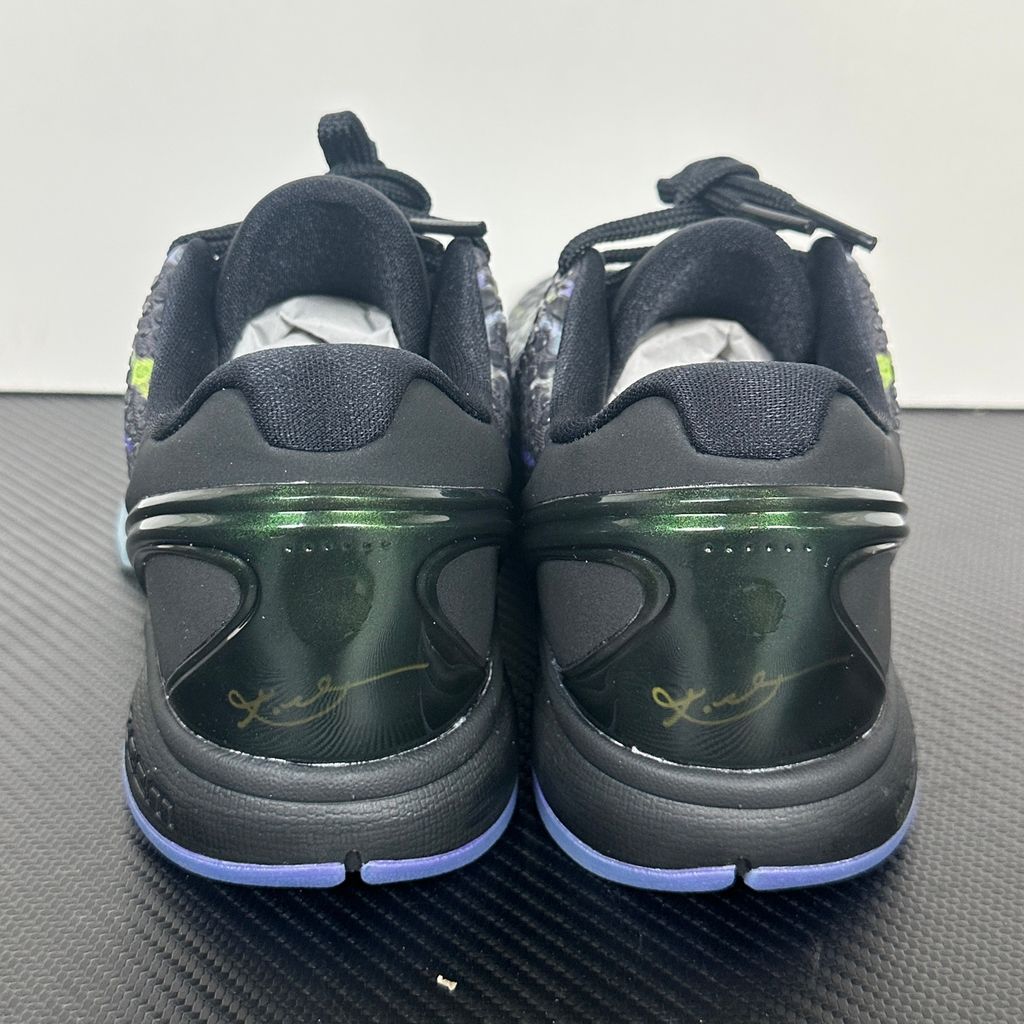 Side profile of the Nike Kobe 6 Protro "Coals" basketball shoe, featuring a stealthy black textured reptilian scale upper, vibrant Venom Green Swoosh and laces, contrasting Purple Venom accents, and a responsive Zoom Air midsole.