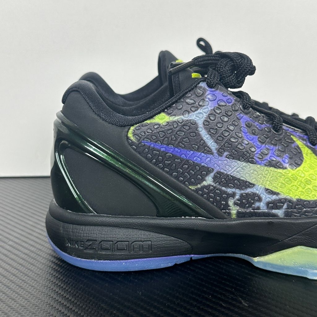 Side profile of the Nike Kobe 6 Protro "Coals" basketball shoe, featuring a stealthy black textured reptilian scale upper, vibrant Venom Green Swoosh and laces, contrasting Purple Venom accents, and a responsive Zoom Air midsole.