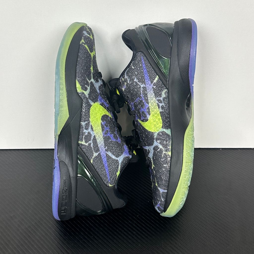 Side profile of the Nike Kobe 6 Protro "Coals" basketball shoe, featuring a stealthy black textured reptilian scale upper, vibrant Venom Green Swoosh and laces, contrasting Purple Venom accents, and a responsive Zoom Air midsole.