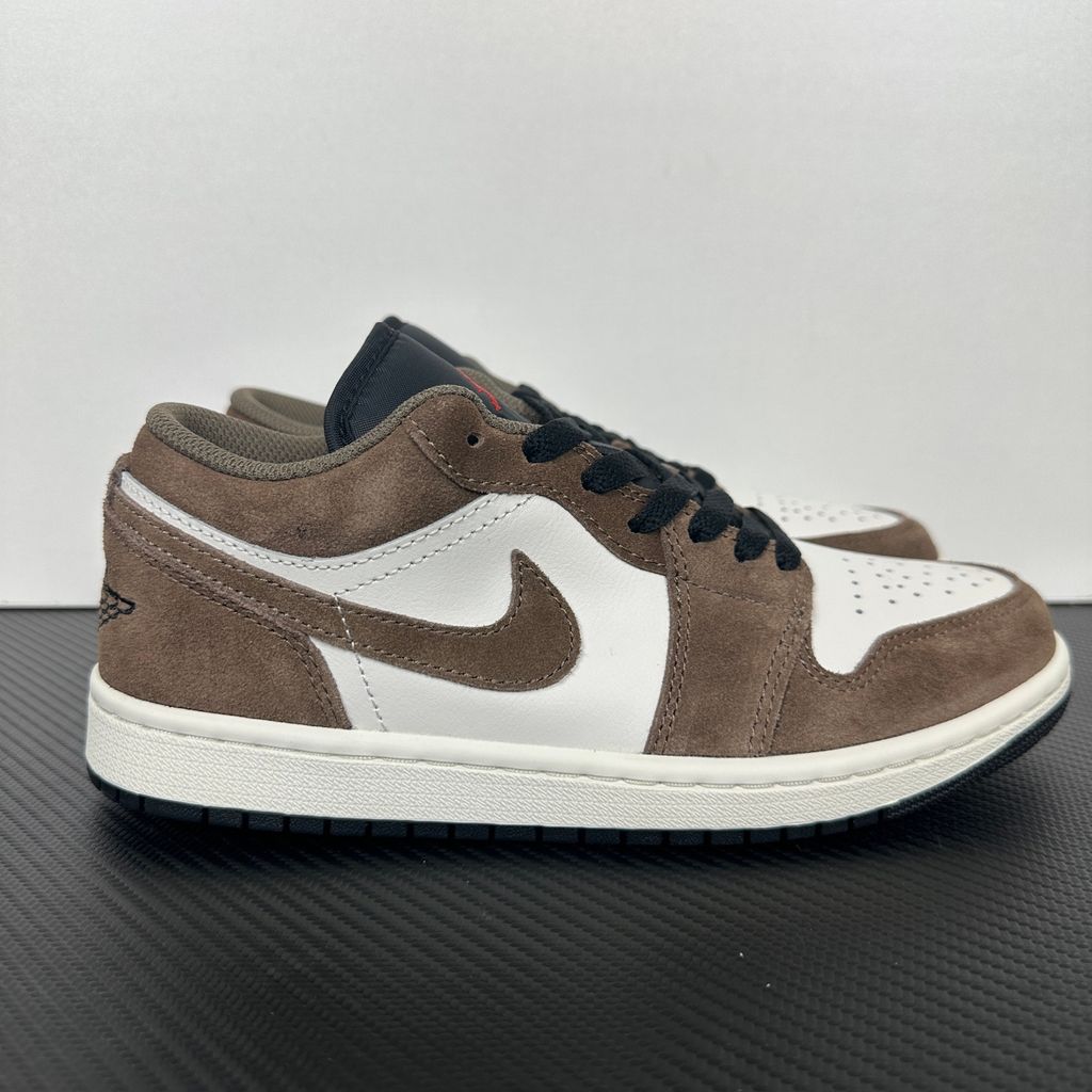 Side profile of the Air Jordan 1 Low sneaker featuring a crisp white leather base, rich earthy brown Palomino overlays, a striking Wild Berry purple Swoosh, and a classic white midsole.