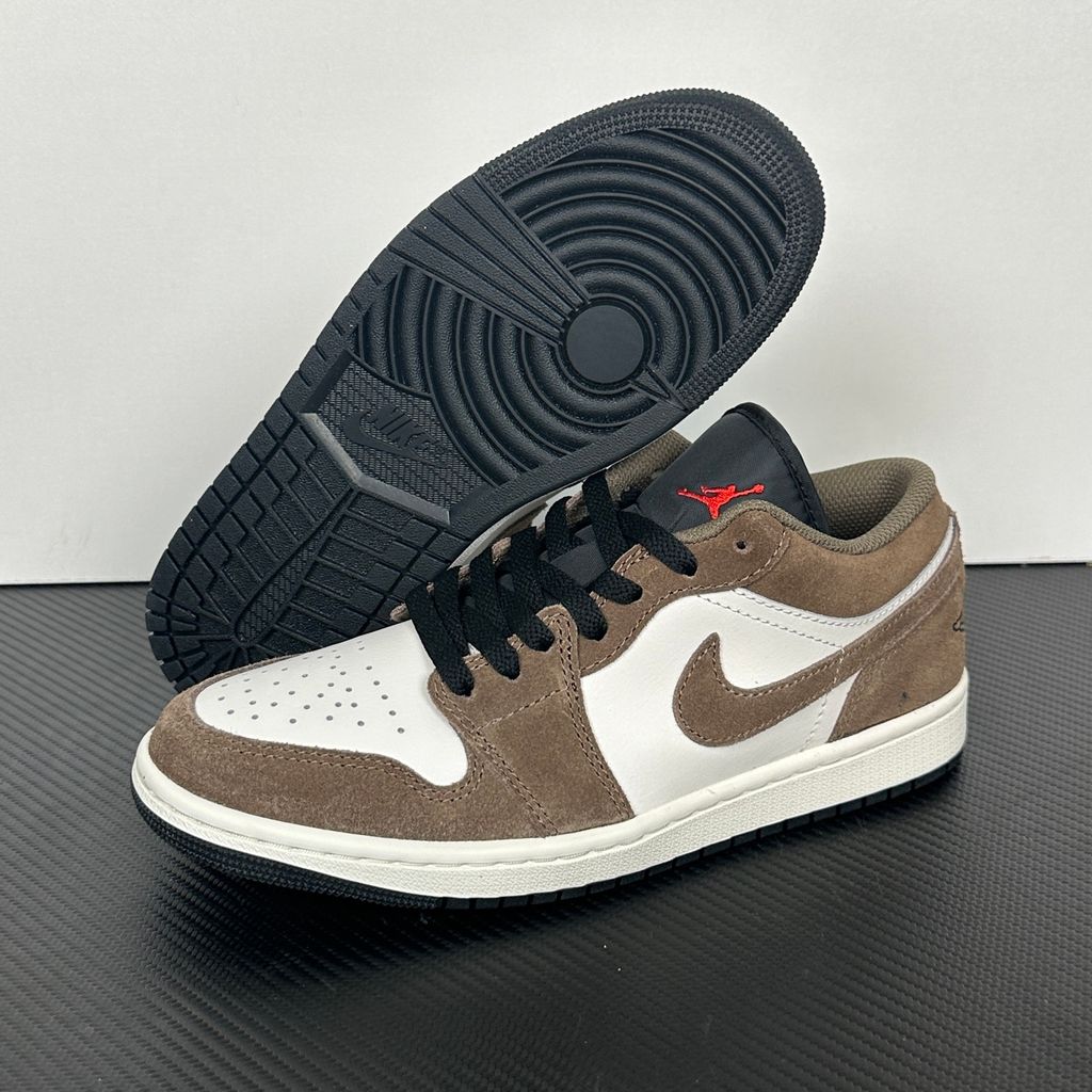 Side profile of the Air Jordan 1 Low sneaker featuring a crisp white leather base, rich earthy brown Palomino overlays, a striking Wild Berry purple Swoosh, and a classic white midsole.