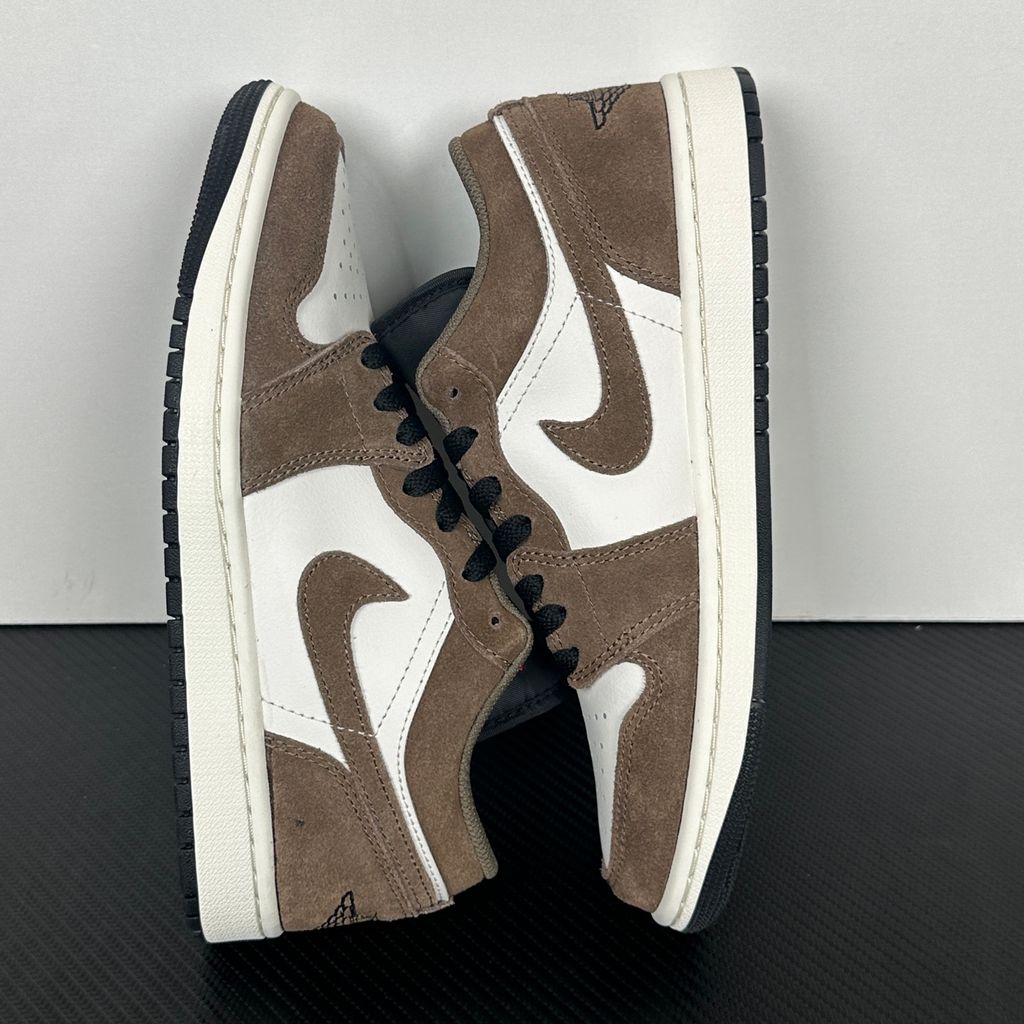 Side profile of the Air Jordan 1 Low sneaker featuring a crisp white leather base, rich earthy brown Palomino overlays, a striking Wild Berry purple Swoosh, and a classic white midsole.