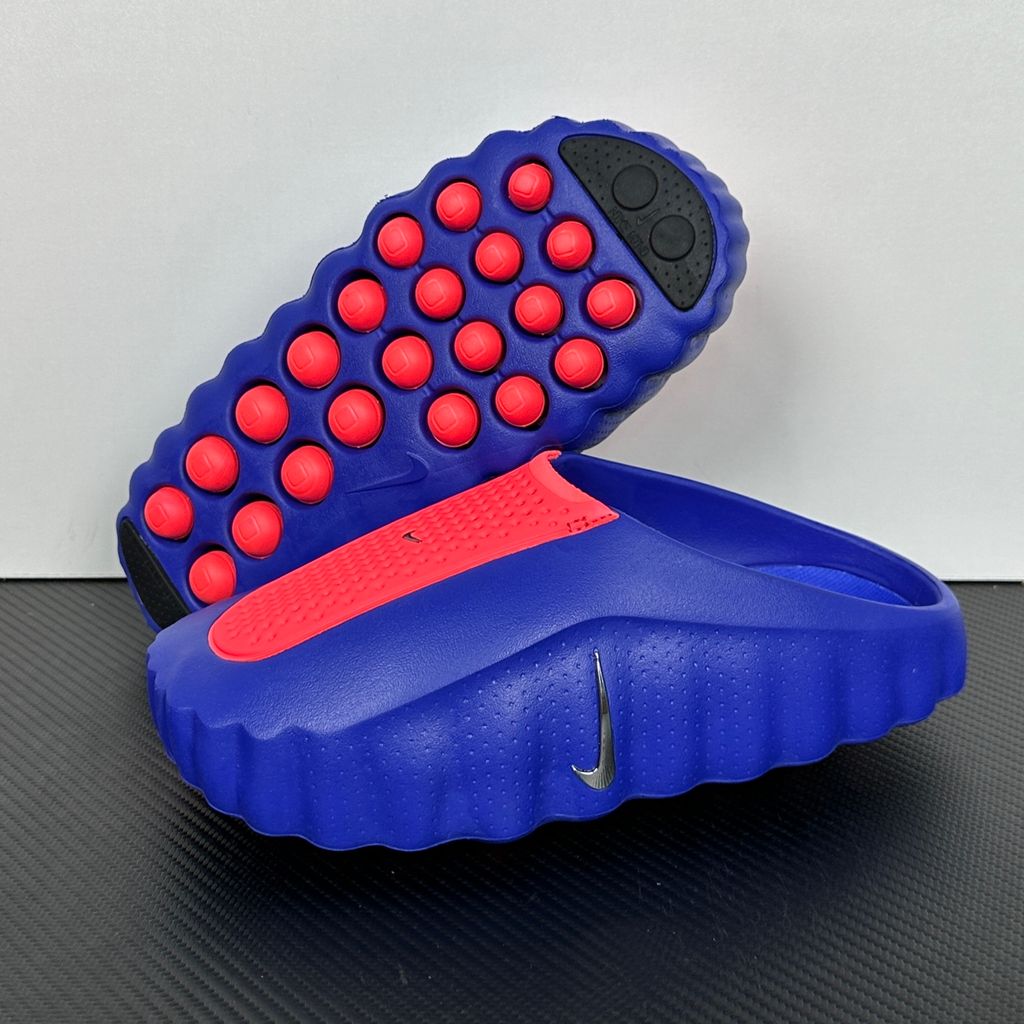 Side profile of the Nike Mind 001 AMP Slide 'Spider-Man' featuring a molded foam construction, iconic red and blue superhero color blocking, subtle web-inspired graphic textures on the strap, and a contoured footbed for all-day comfort.