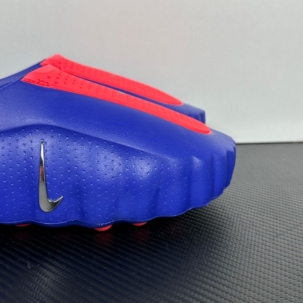 Side profile of the Nike Mind 001 AMP Slide 'Spider-Man' featuring a molded foam construction, iconic red and blue superhero color blocking, subtle web-inspired graphic textures on the strap, and a contoured footbed for all-day comfort..jpg