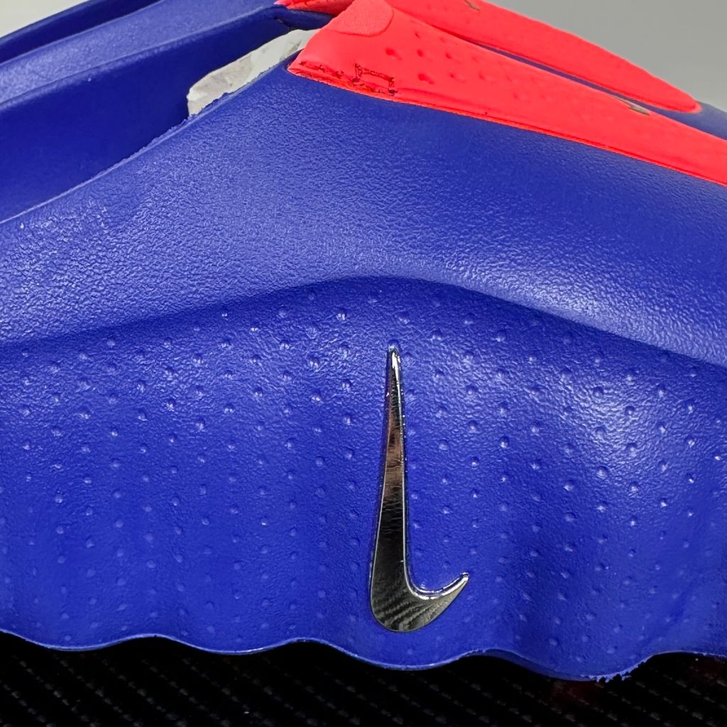 Side profile of the Nike Mind 001 AMP Slide 'Spider-Man' featuring a molded foam construction, iconic red and blue superhero color blocking, subtle web-inspired graphic textures on the strap, and a contoured footbed for all-day comfort.