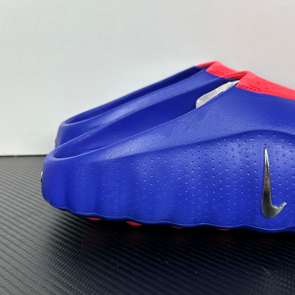 Side profile of the Nike Mind 001 AMP Slide 'Spider-Man' featuring a molded foam construction, iconic red and blue superhero color blocking, subtle web-inspired graphic textures on the strap, and a contoured footbed for all-day comfort.