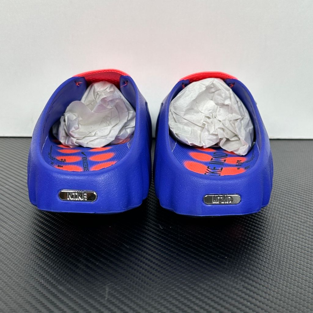 Side profile of the Nike Mind 001 AMP Slide 'Spider-Man' featuring a molded foam construction, iconic red and blue superhero color blocking, subtle web-inspired graphic textures on the strap, and a contoured footbed for all-day comfort.