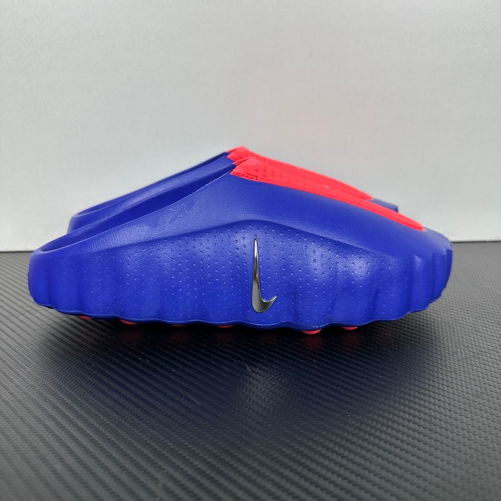 Side profile of the Nike Mind 001 AMP Slide 'Spider-Man' featuring a molded foam construction, iconic red and blue superhero color blocking, subtle web-inspired graphic textures on the strap, and a contoured footbed for all-day comfort.